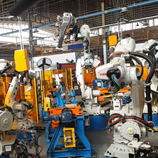 Manufacturing robots working together in a manufacturing facility