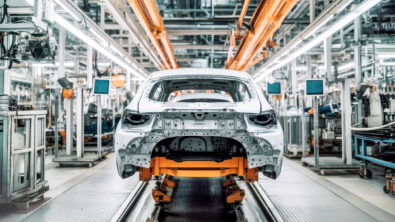 Assembly of an electric vehicle in a modern and technologically advanced automotive plant using cutting-edge manufacturing processes and generative design.