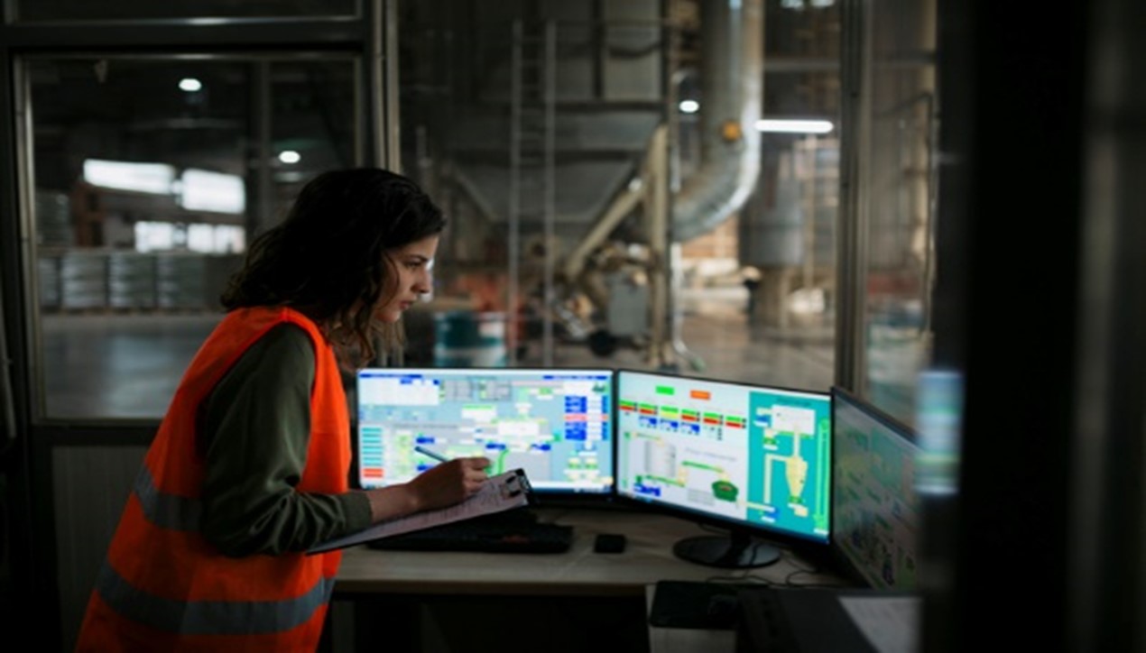 Factory worker using a cybersecure network in an automotive manufacturing plant