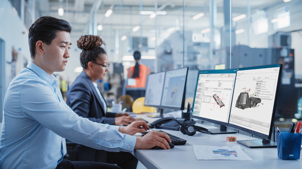 Engineers working on a CAD file for a product component on the computer