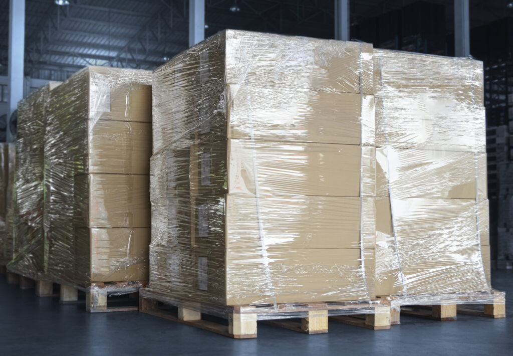 Four pallets, each stacked with five boxes and wrapped in clear plastic for shipping