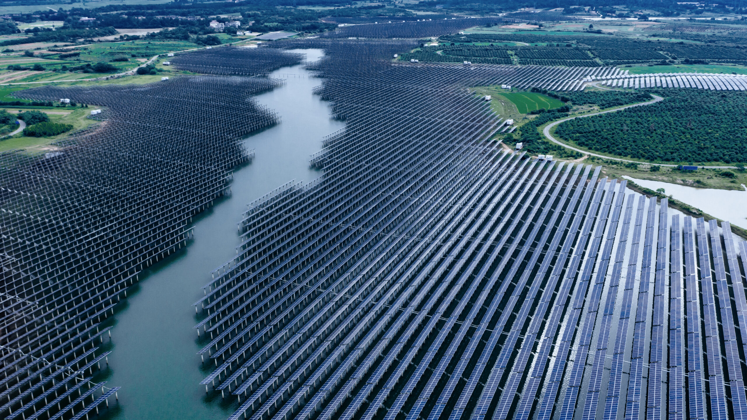 Large solar farm surrounded by green field
