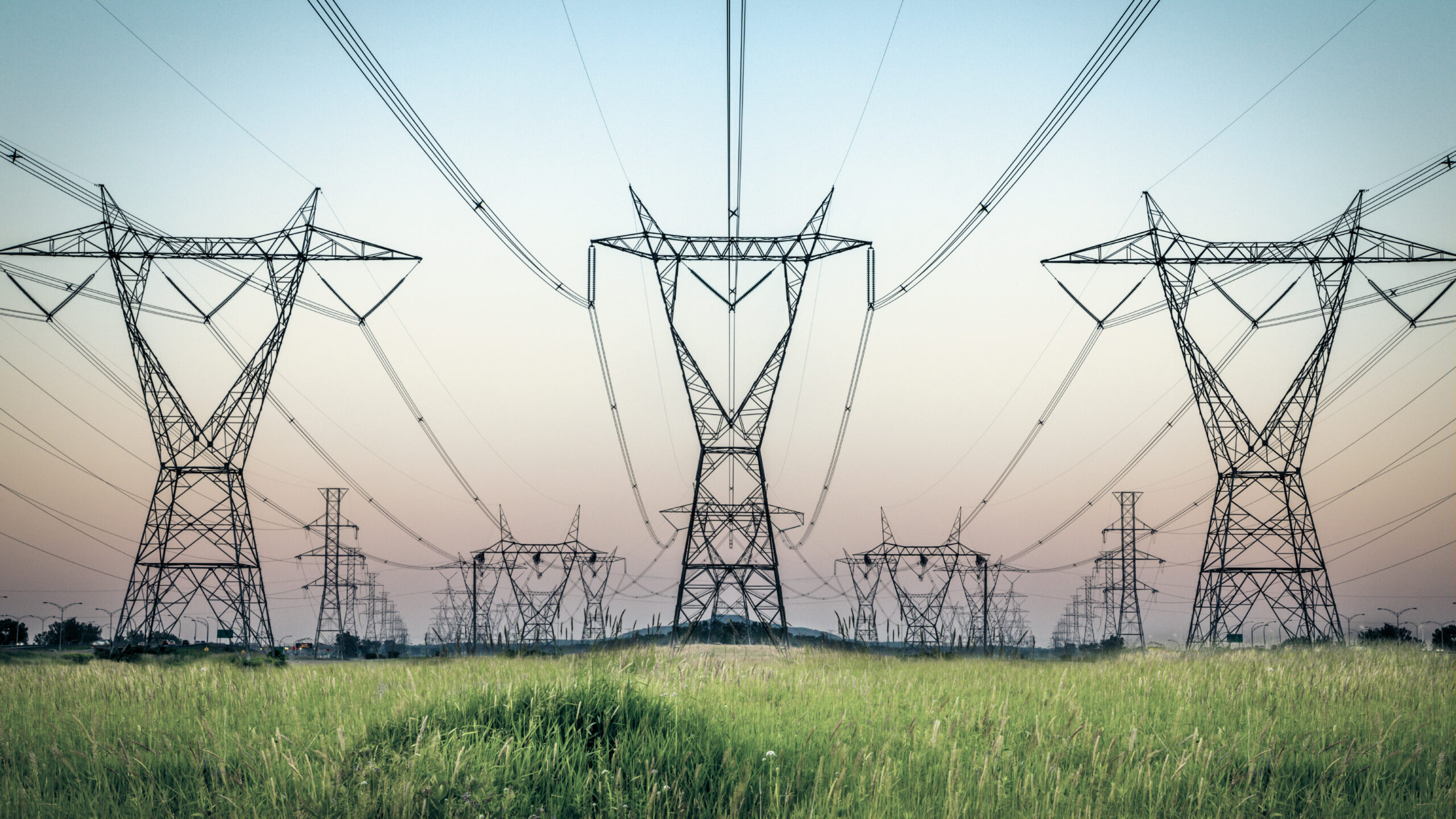 Power lines above a green field