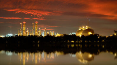 Energy, gas and chemical plant across water in dusk sky