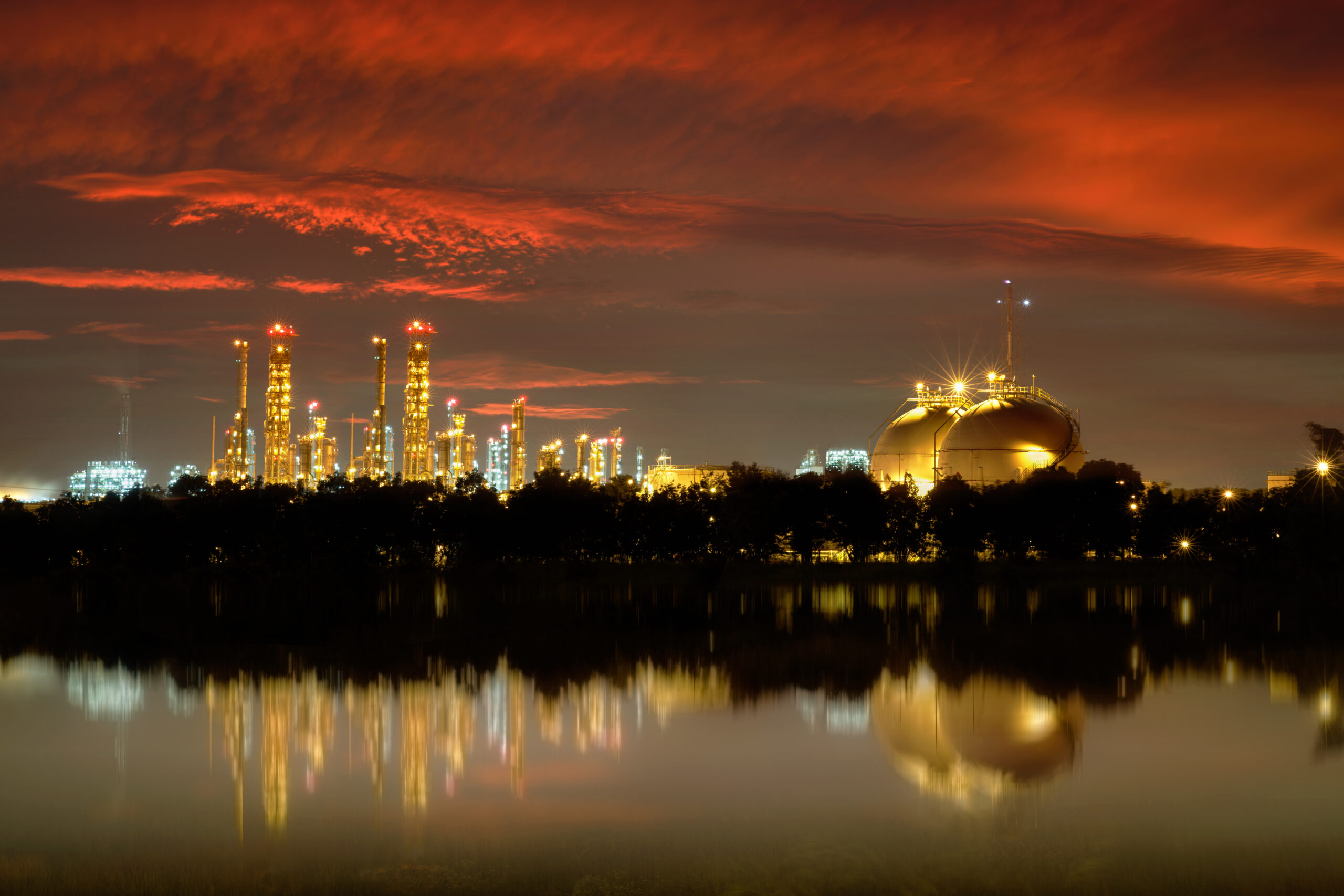 Energy, gas and chemical plant across water in dusk sky