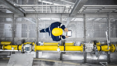 Engineer using CFD simulation on a tablet in an energy plant