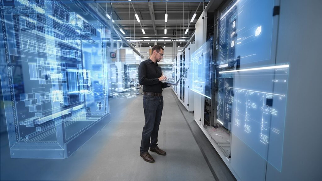 A man stands in front of industrial machinery with digital graphics eluding to IT/OT Convergence