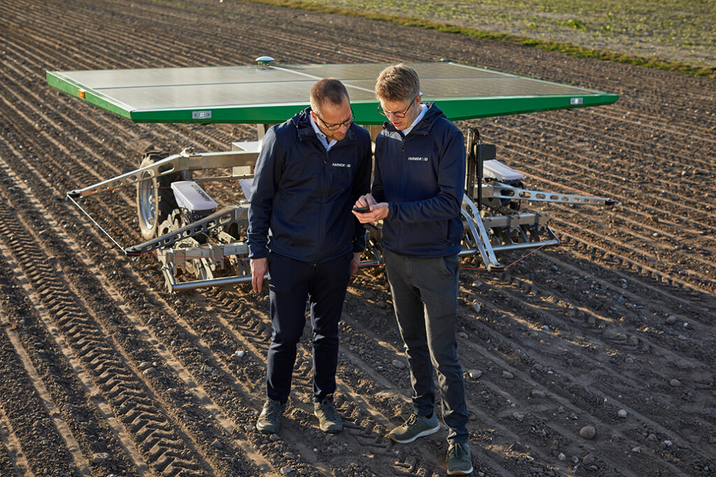 Two engineers working remotely via SaaS applications on their device