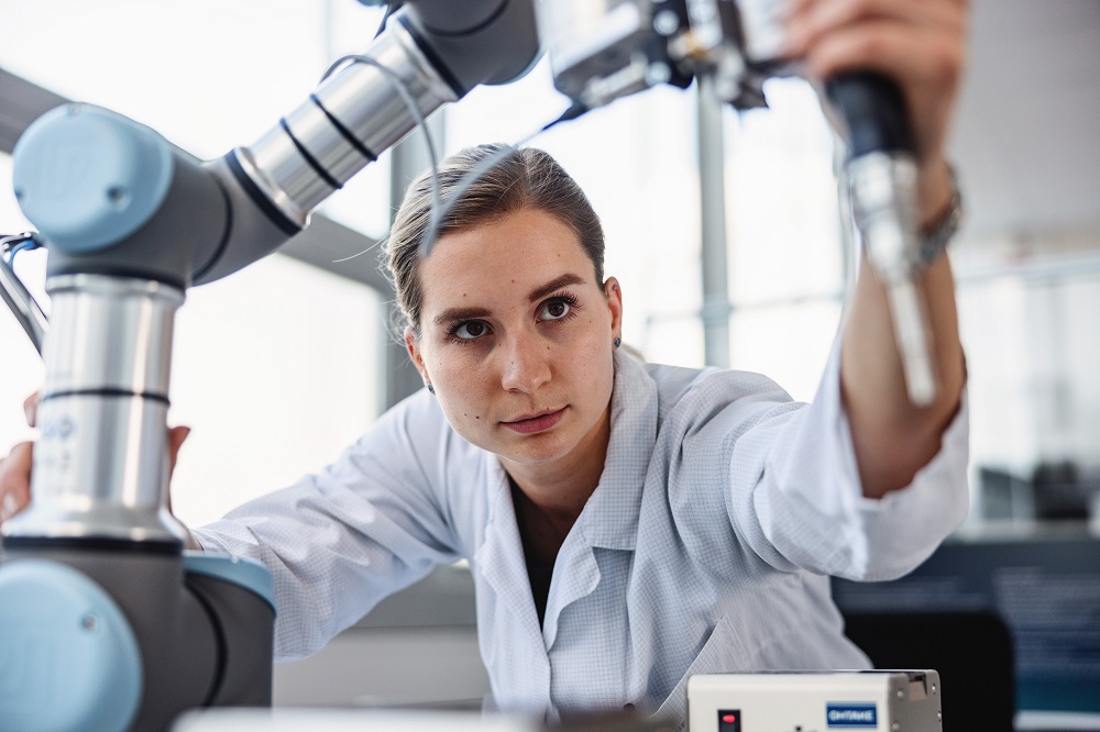 Engineer looking at a robotic arm