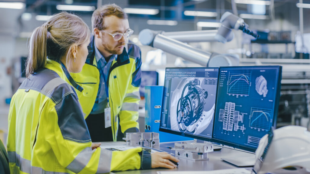 Two engineers reviewing data on a computer