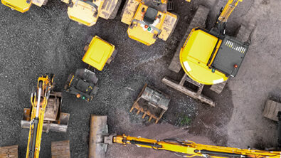 Heavy equipment machines arranged at a construction site, representing configuration design in action.
