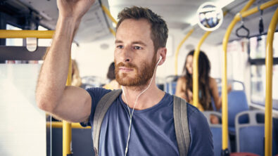 Portrait of young man with headphones in a bus