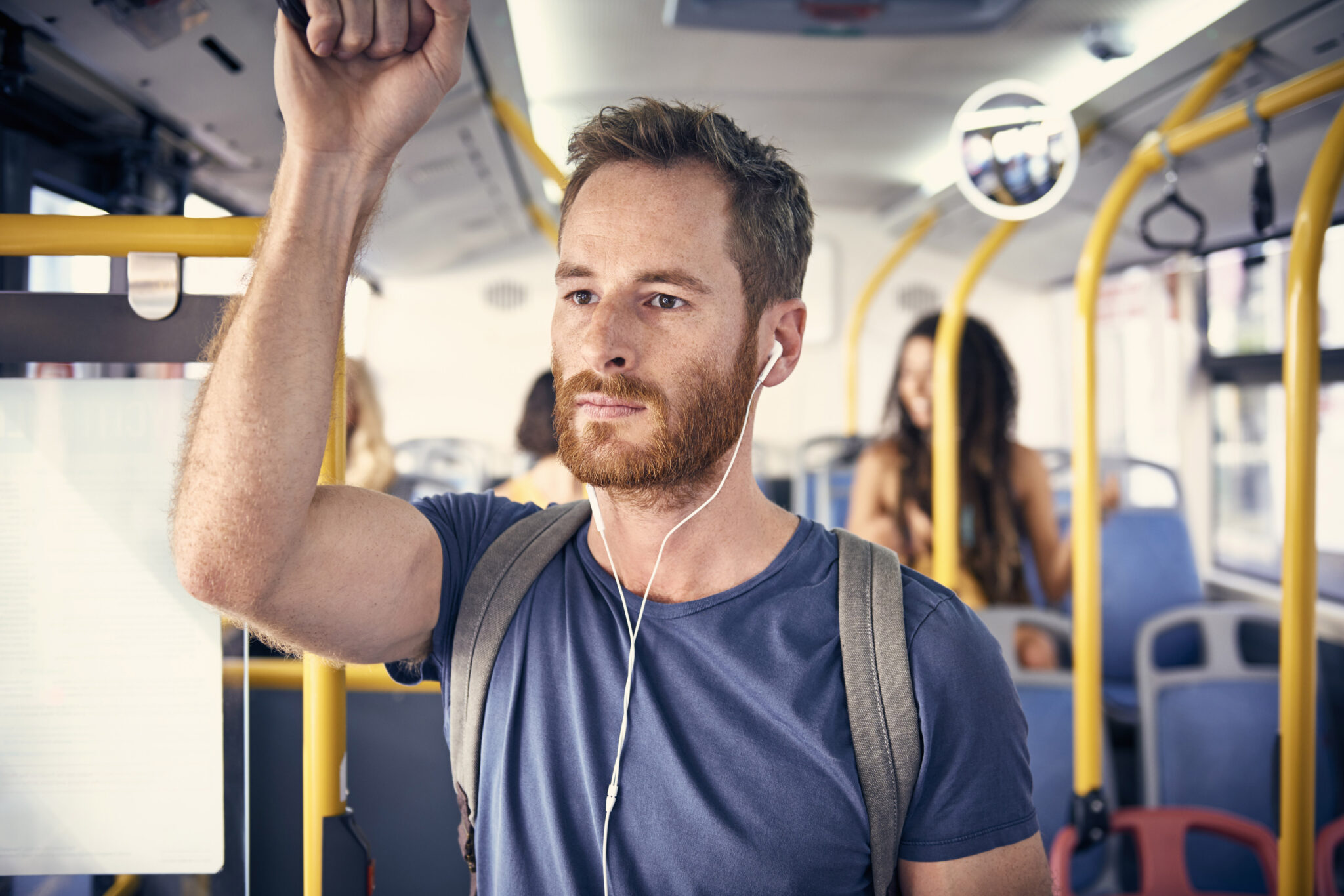 Portrait of young man with headphones in a bus