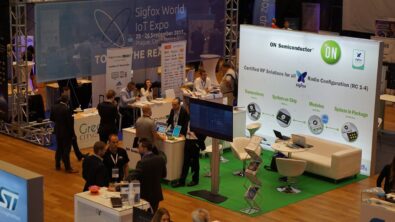 An image of a busy tech convention show floor with multiple booths on the show floor.