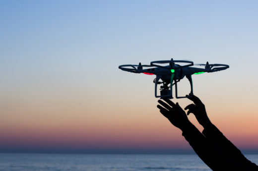 Viareggio, Italy - October 30, 2014: Drone takes off from the operator's hand with camera at sunset Quadcopter industry is told to be growing at triple digitsevery year, for a market expected to pass the 20 billion in the 2020. The dji is a chinese company leader of quadcopter industry, and the phantom is expected to be the top seller gift for christmas 2015