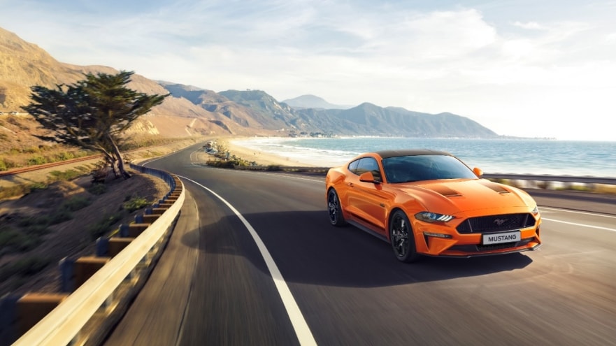 The displayed orange Ford Mustang sports car features a 2.3-litre EcoBoost downsized engine.