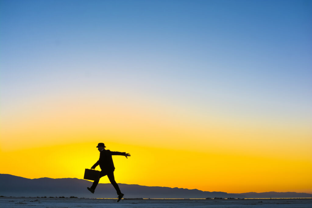 Leaping man with suitcase