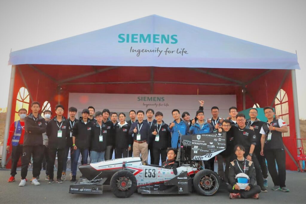 Group photo of DIAN Racing Tongi University Formula Electric team and Siemens booth staff