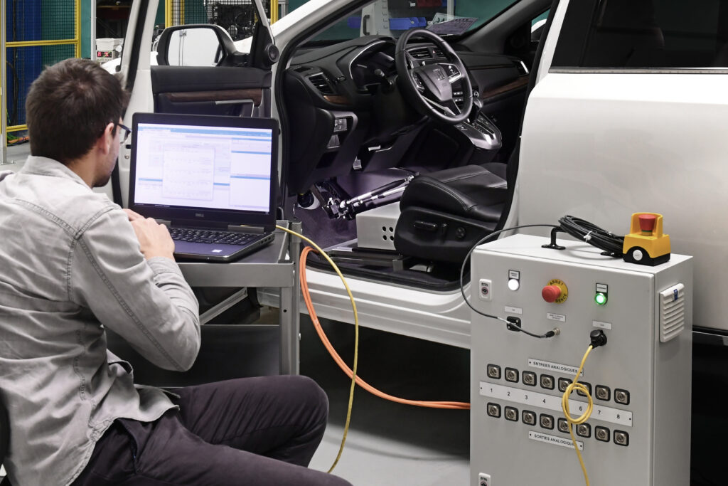 Engineer observing a driving robot at our vehicle energy management facility