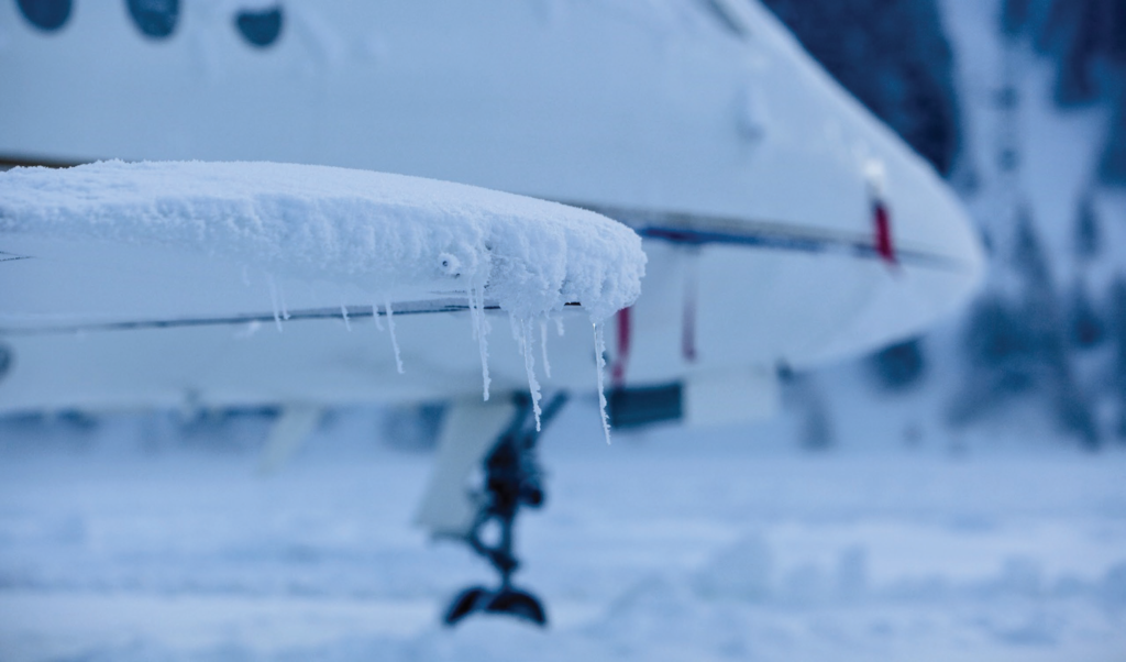 Image showing ice and snow on an airplane wing.