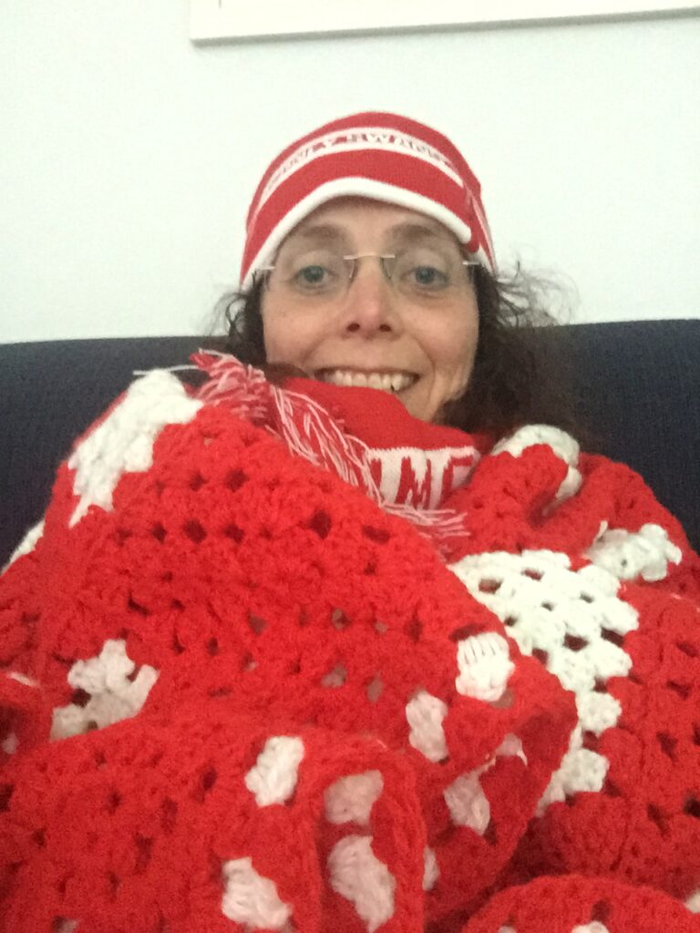 Sam Murray all dressed up as a fan in the colors of the Sydney Swans, an Australian rules football club. 