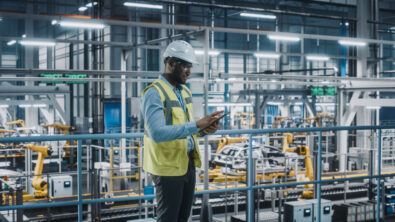 Man in factory looking at a tablet