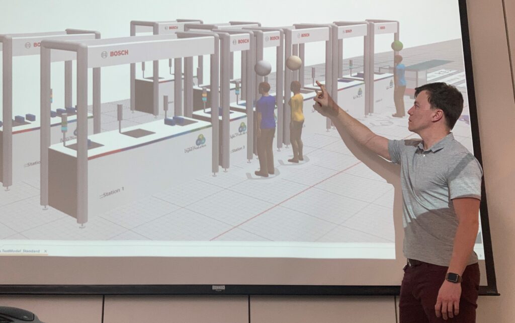 Carsten Meyer delivering a presentation on the Bosch Factory Simulation Library during the Plant Simulation User Meeting, representing Bosch’s Corporate Manufacturing Services department.