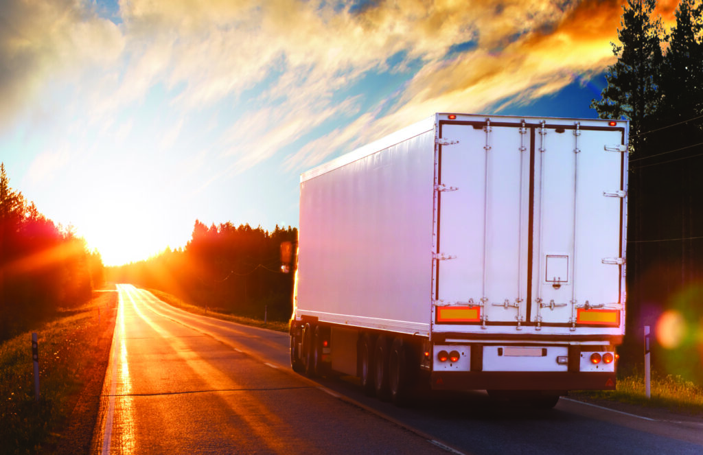 Truck on the asphalt road in the evening