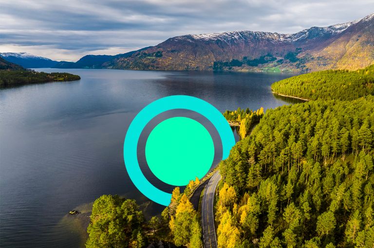 Scenic image of blue mountains and green trees symbolic of a sustainable value chain