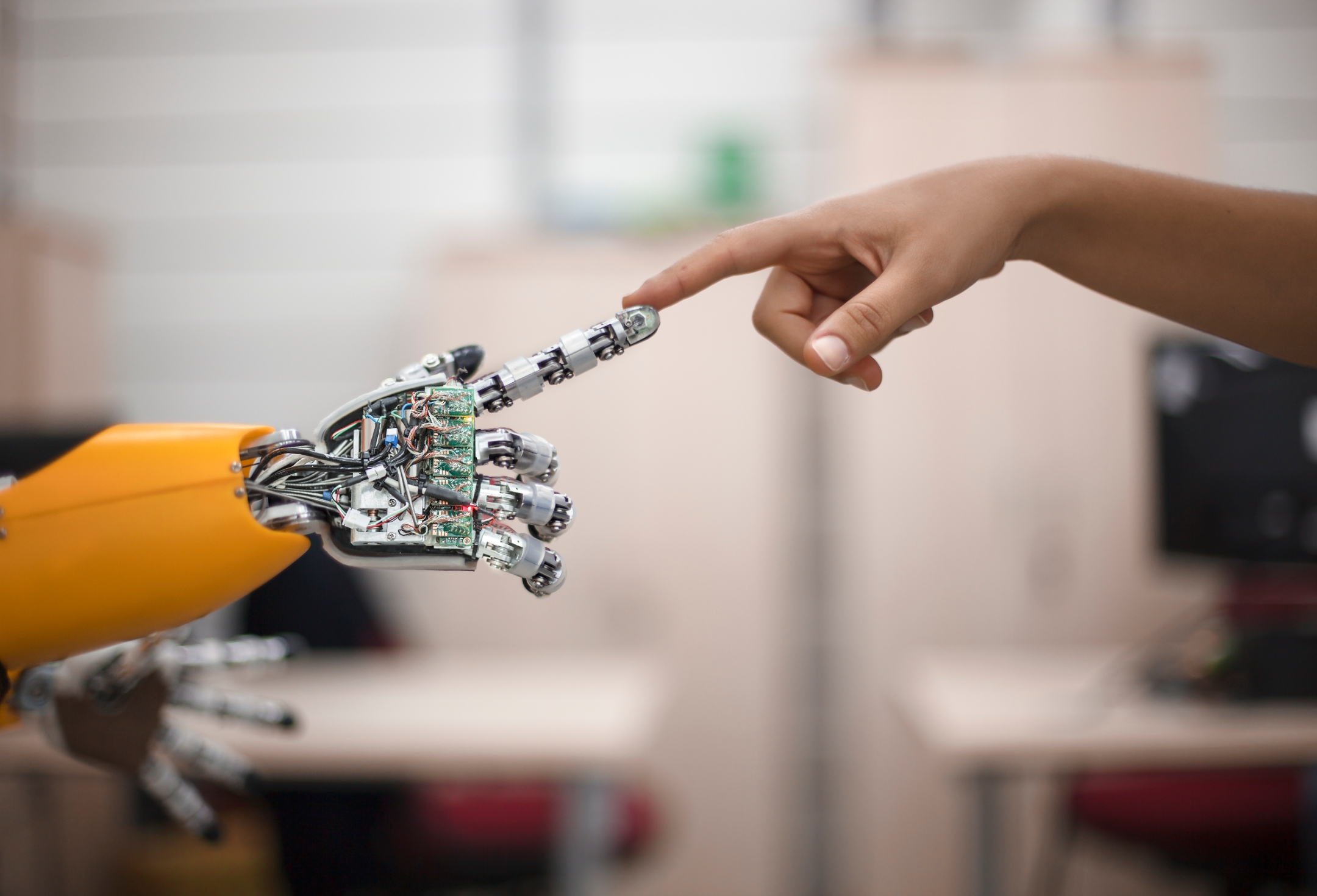 Human and robot hands touching